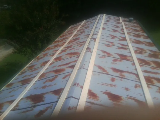 Rusted metal roof panels with new wood purlins before replacement — Storm Damage Roof Repair in Mount Shasta by Roofing Brothers